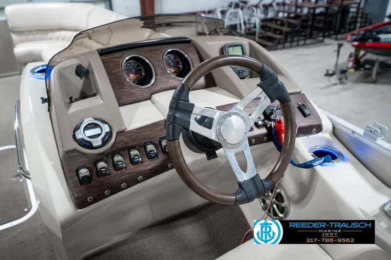 Slide: The Image of 2014 Bennington 2250 RCB boat dashboard with steering wheel and control panel. - 34