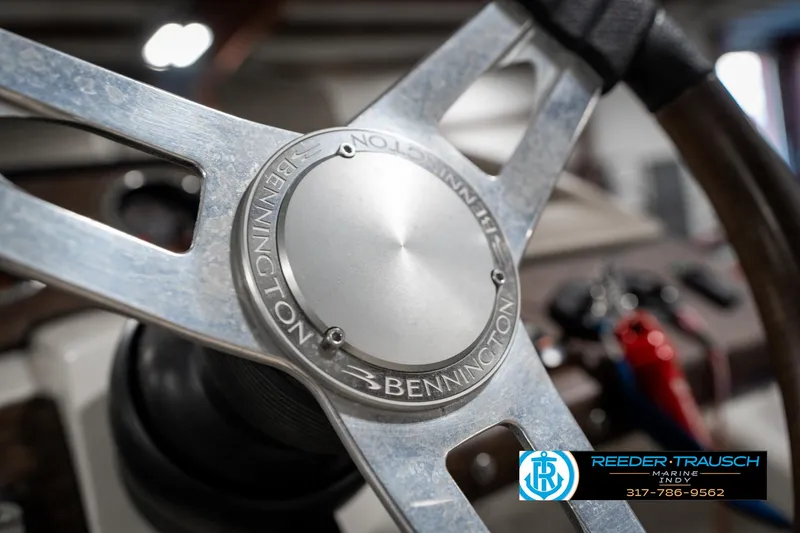 Slide: The Image of Steering wheel of 2014 Bennington 2250 RCB boat, featuring metallic design and branding. - 35