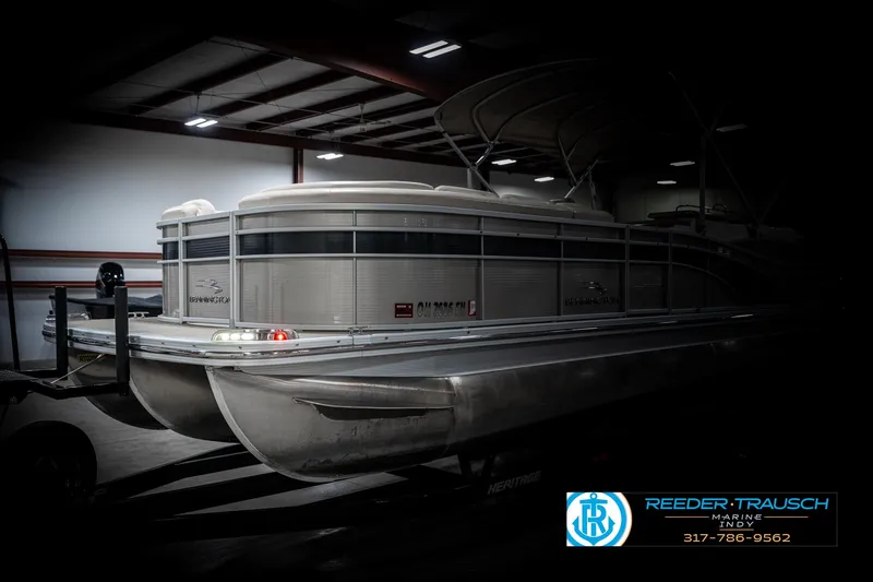 Slide: The Image of 2014 Bennington 2250 RCB pontoon boat in a dimly lit indoor setting. - 4