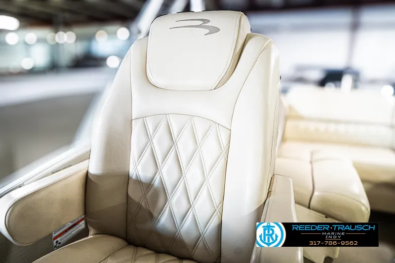 Slide: The Image of Luxurious beige seating on a 2014 Bennington 2250 RCB boat, featuring diamond stitching. - 42