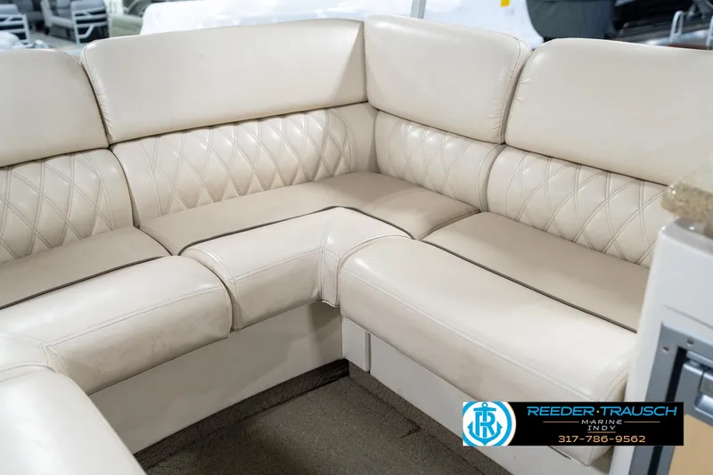 Slide: The Image of 2014 Bennington 2250 RCB boat interior with beige leather seating and diamond stitching. - 44
