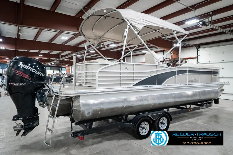 Slide: The Image of 2014 Bennington 2250 RCB pontoon boat with Mercury outboard motor in indoor storage. - 8