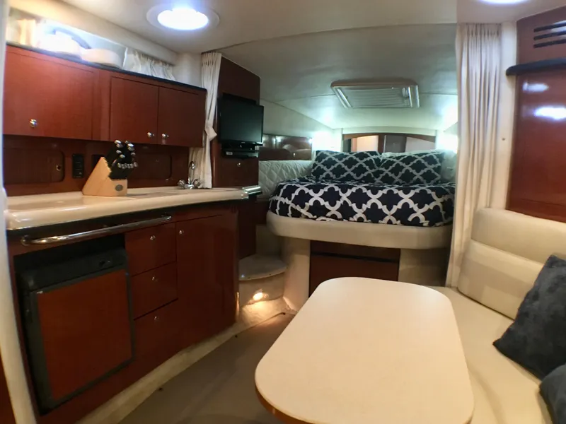Slide: The Image of Interior of 2002 Sea Ray 320 Sundancer with cozy cabin and modern amenities. - 10