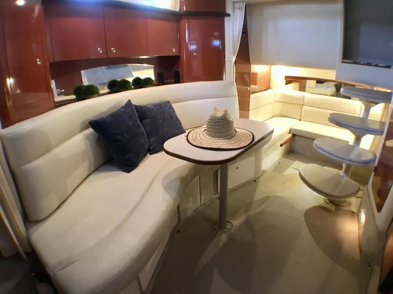 Slide: The Image of Interior of 2002 Sea Ray 320 Sundancer with plush seating and elegant decor. - 11