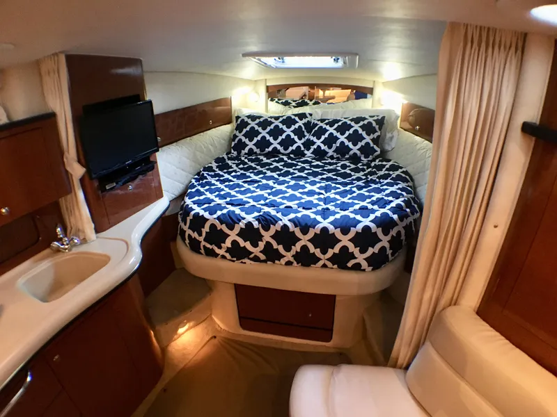 Slide: The Image of Interior of 2002 Sea Ray 320 Sundancer with cozy bed and modern amenities. - 12