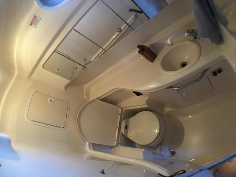 Slide: The Image of Bathroom interior of 2002 Sea Ray 320 Sundancer yacht, featuring toilet and sink. - 15