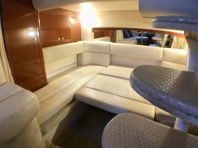 Slide: The Image of Interior of 2002 Sea Ray 320 Sundancer yacht with plush seating and elegant design. - 18
