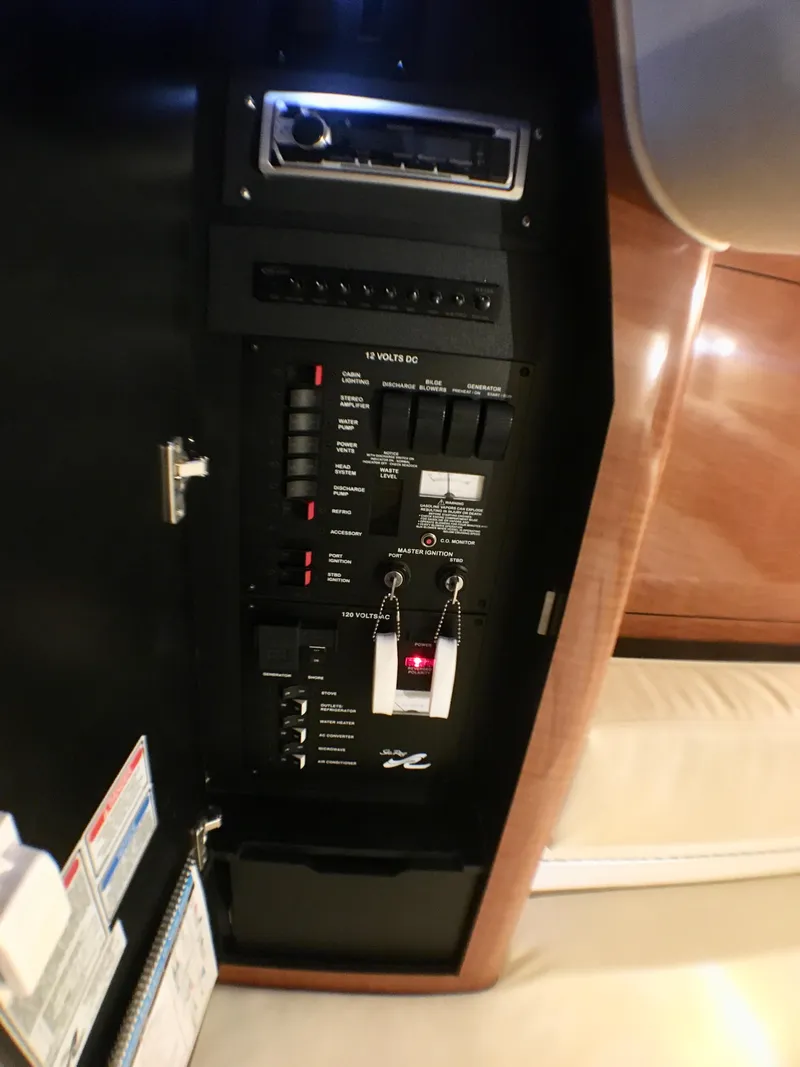 Slide: The Image of Control panel inside 2002 Sea Ray 320 Sundancer yacht, featuring switches and indicators. - 19