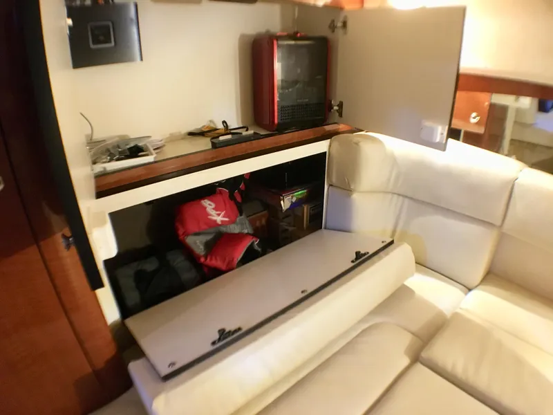 Slide: The Image of Interior of 2002 Sea Ray 320 Sundancer with white seating and storage compartment. - 20