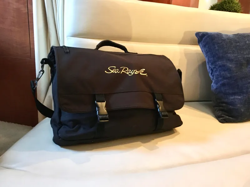 Slide: The Image of Sea Ray branded bag on a beige sofa, 2002 Sea Ray 320 Sundancer interior. - 22