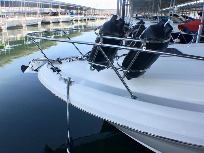 Slide: The Image of 2002 Sea Ray 320 Sundancer docked, featuring sleek bow design and fenders. - 4