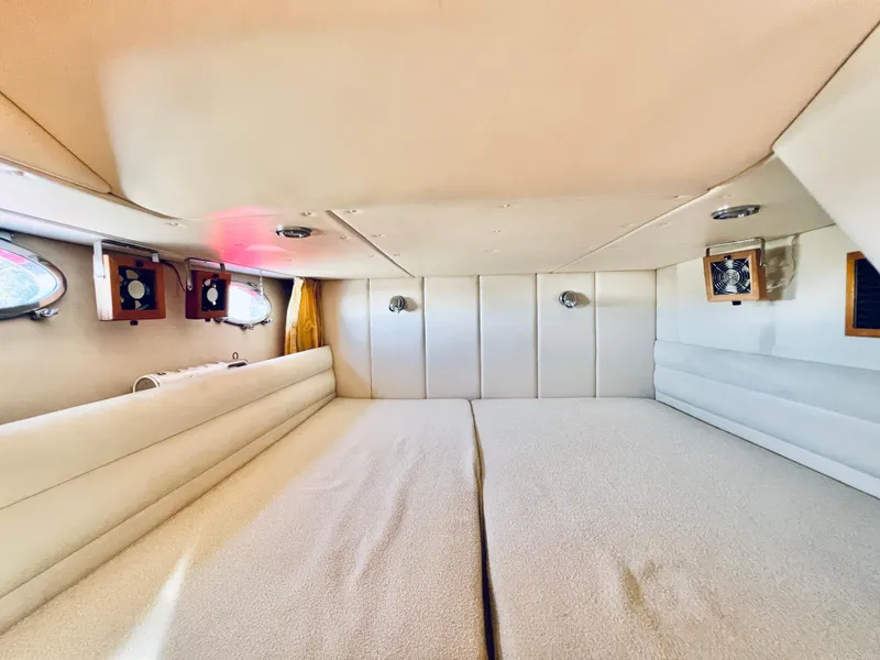 Slide: The Image of Interior cabin of 2007 Windy Typhoon 43 yacht with cozy bedding and porthole windows. - 14
