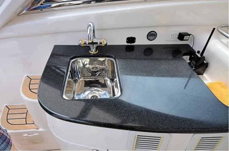 Slide: The Image of Luxury yacht sink area on 2007 Windy Typhoon 43 with sleek black countertop. - 19