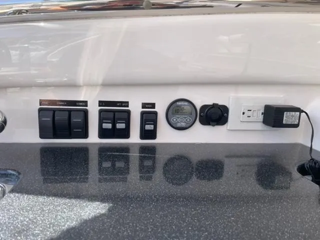 Slide: The Image of Control panel of a 2007 Windy Typhoon 43 boat with switches and gauges. - 35