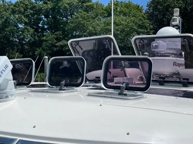 Slide: The Image of Windy Typhoon 43 yacht deck with open hatches, 2007 model, surrounded by lush greenery. - 45