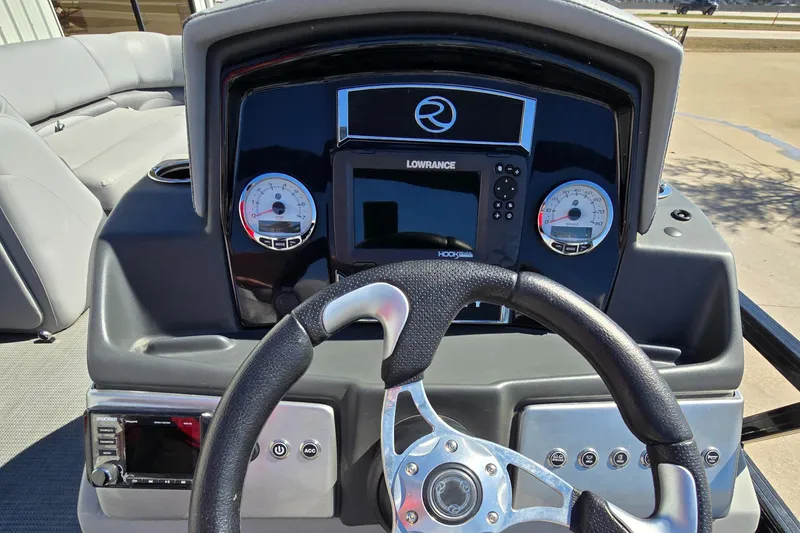 Slide: The Image of 2023 Regency 250 DL3 boat dashboard with steering wheel and control panel. - 4