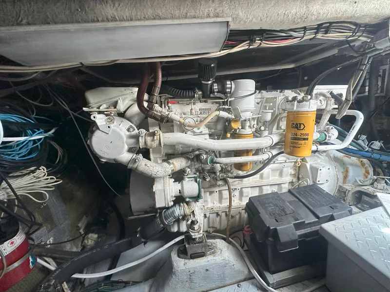 Slide: The Image of Engine compartment of a 1990 Rampage 36 Sportfisherman boat, featuring detailed mechanical components. - 14