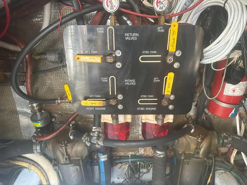 Slide: The Image of Engine room of 1990 Rampage 36 Sportfisherman with fuel valve panel and hoses. - 15