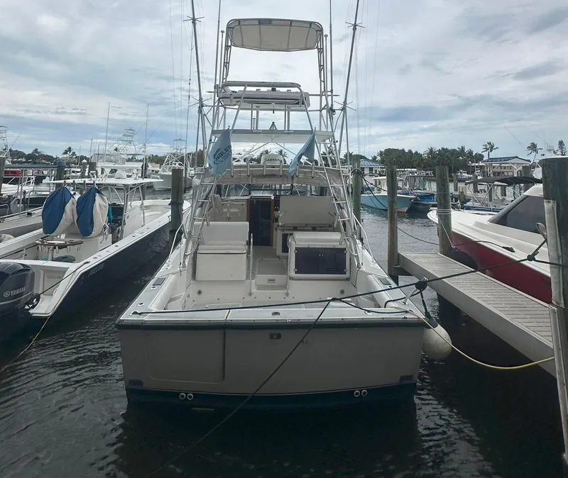 Slide: The Image of 1990 Rampage 36 Sportfisherman boat docked at marina, rear view. - 18