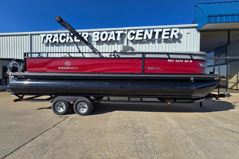 The Image of 2023 Regency 250 DL3 pontoon boat at Tracker Boat Center, red and black design. - 1