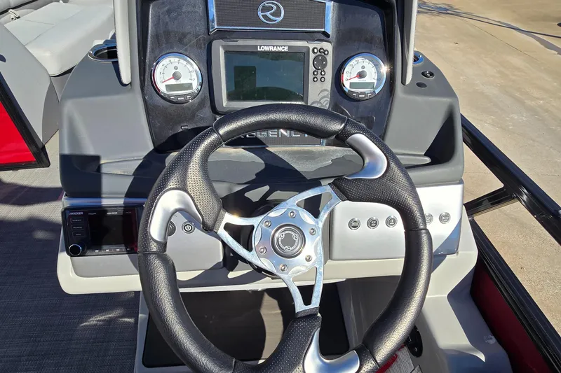 Slide: The Image of 2023 Regency 250 DL3 boat dashboard with steering wheel and control panel. - 4
