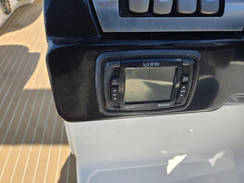 Slide: The Image of Control panel of a 2016 AquaPatio 240 CB boat with Infinity stereo system. - 13