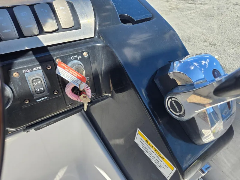 Slide: The Image of Control panel of 2016 AquaPatio 240 CB boat with ignition and throttle. - 14