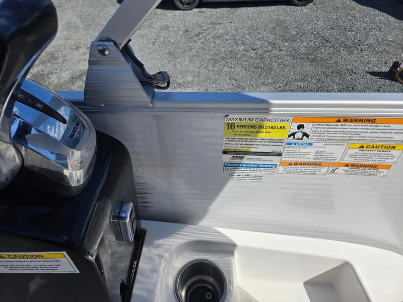 Slide: The Image of Control panel and capacity warnings on 2016 AquaPatio 240 CB boat. - 15