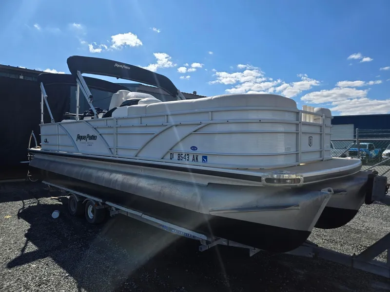 Slide: The Image of 2016 AquaPatio 240 CB pontoon boat on trailer under blue sky. - 2