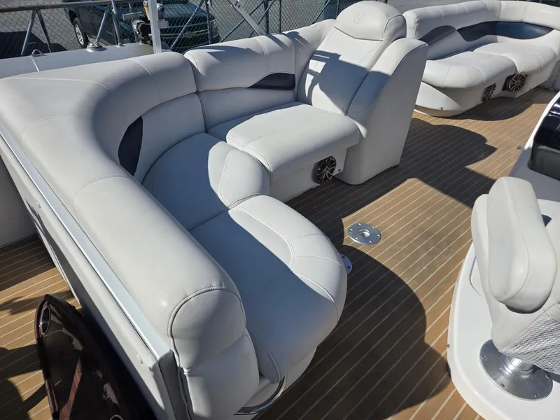 Slide: The Image of 2016 AquaPatio 240 CB boat with luxurious white seating and wood-style flooring. - 20