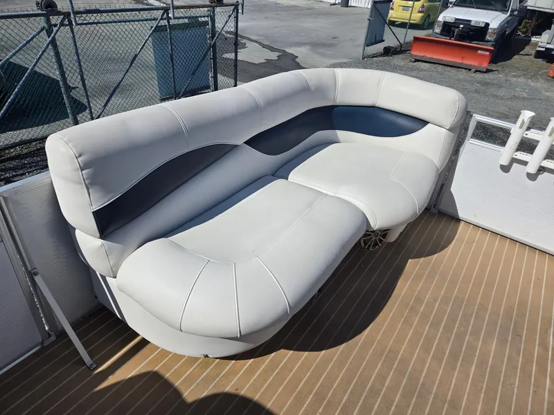 Slide: The Image of 2016 AquaPatio 240 CB boat with spacious, cushioned seating on deck. - 25