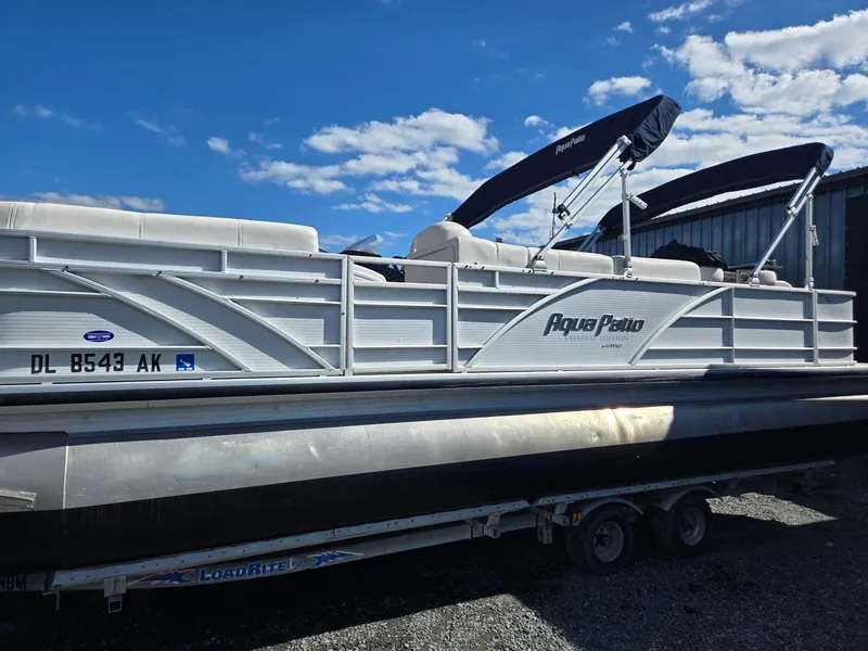 Slide: The Image of 2016 AquaPatio 240 CB pontoon boat on trailer under blue sky. - 3