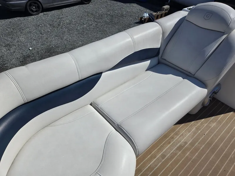 Slide: The Image of 2016 AquaPatio 240 CB boat interior with white and blue seating. - 7