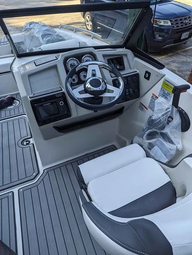 Slide: The Image of 2024 Starcraft SVX 210 IO boat cockpit with steering wheel and dashboard controls. - 5