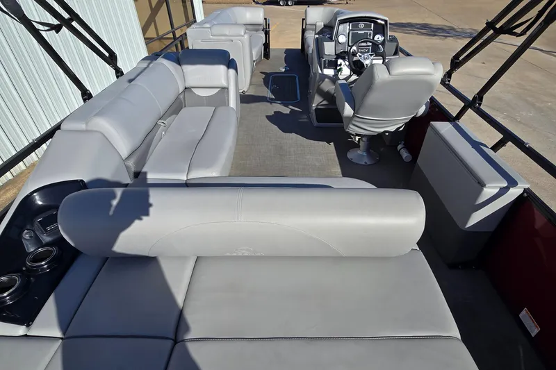 Slide: The Image of 2023 Regency 250 DL3 pontoon boat interior with spacious seating and modern helm. - 4