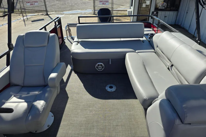 Slide: The Image of 2023 Regency 250 DL3 pontoon boat interior with gray seating and spacious layout. - 6