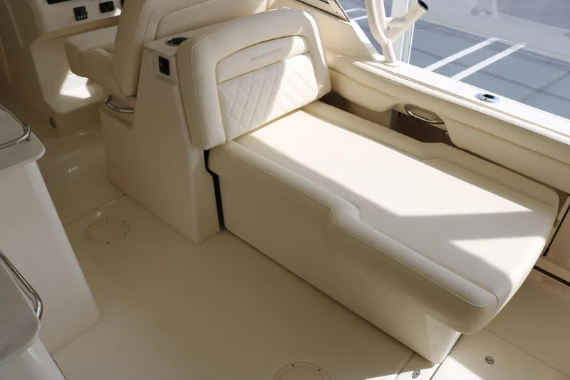 Slide: The Image of 2023 Grady-White Freedom 285 boat interior with beige seating and elegant design. - 10