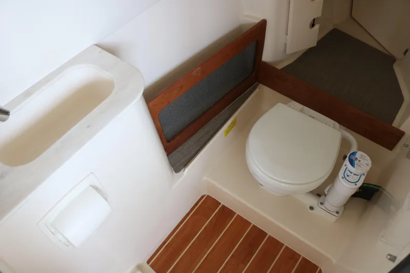 Slide: The Image of 2023 Grady-White Freedom 285 boat bathroom with toilet and sink. - 11