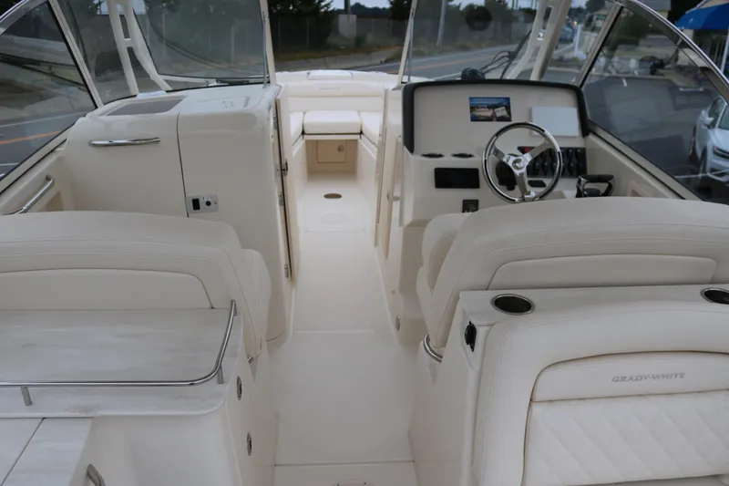 Slide: The Image of 2023 Grady-White Freedom 285 boat interior with luxurious seating and modern dashboard. - 4