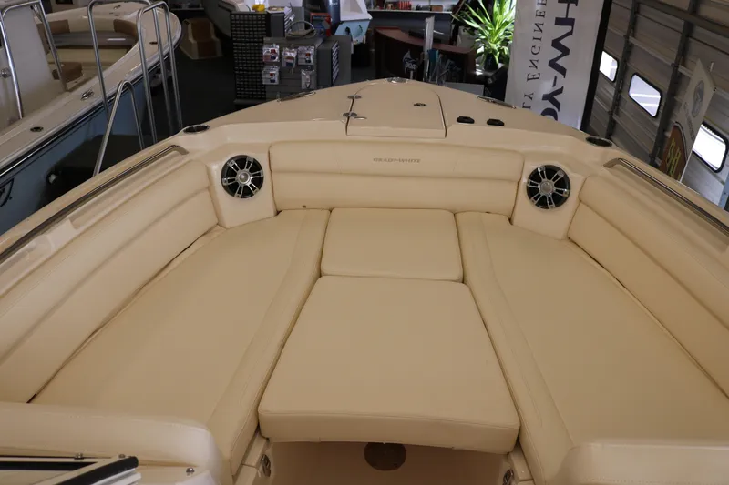 Slide: The Image of 2023 Grady-White Freedom 285 boat interior with beige seating and speakers. - 6