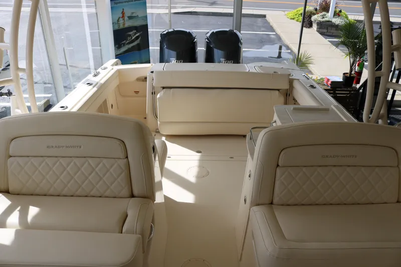 Slide: The Image of 2023 Grady-White Freedom 285 boat interior with cushioned seating and twin engines. - 7