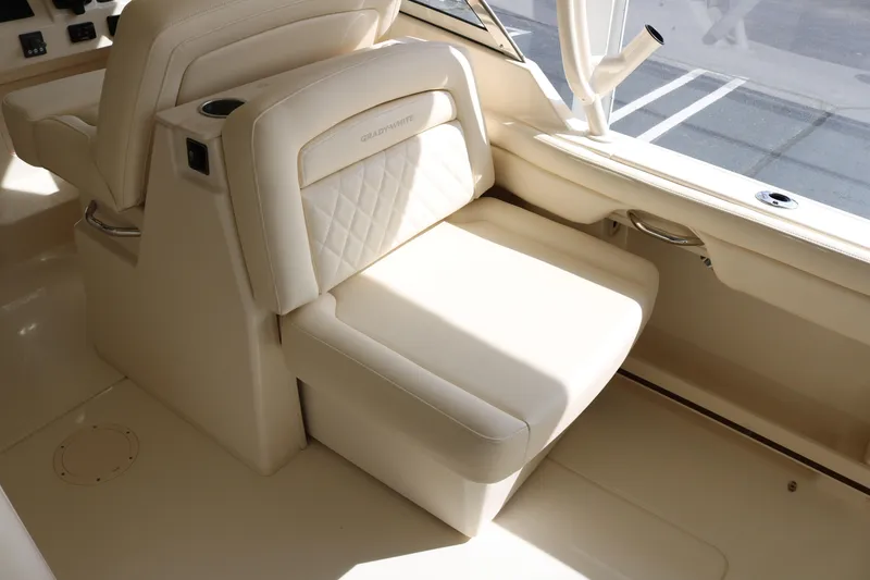 Slide: The Image of 2023 Grady-White Freedom 285 boat interior with beige seating and elegant design. - 9