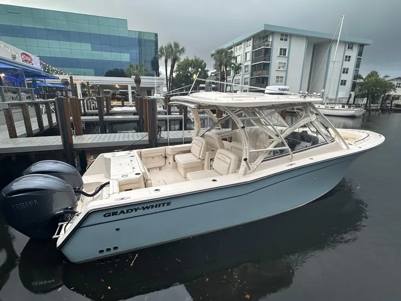 Slide: The Image of 2023 Grady-White Freedom 307 boat docked at marina, overcast sky. - 11