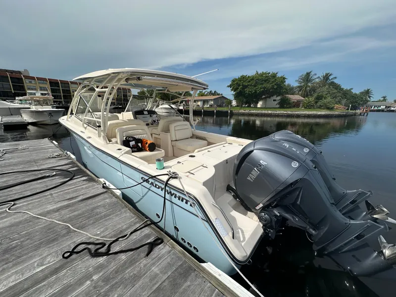 Slide: The Image of 2023 Grady-White Freedom 307 boat docked, featuring Yamaha outboard engines. - 9