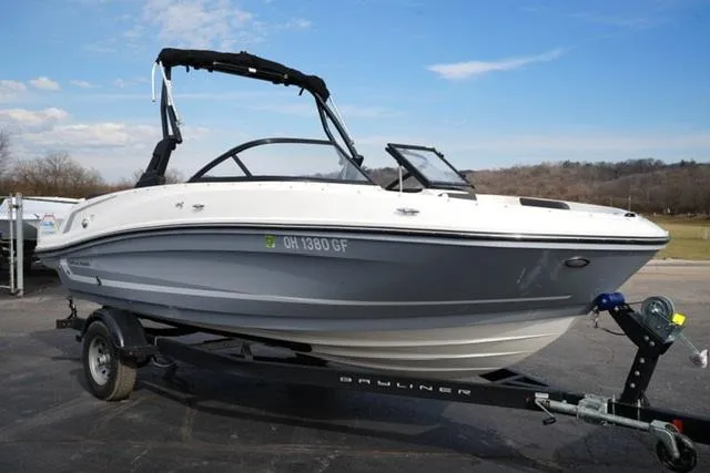 Slide: The Image of 2021 Bayliner VR5 Bowrider I/O on trailer, parked outdoors under clear sky. - 3