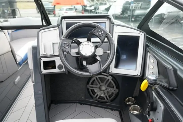 Slide: The Image of Cockpit of 2019 Supra SE 450 boat with modern steering and digital displays. - 11