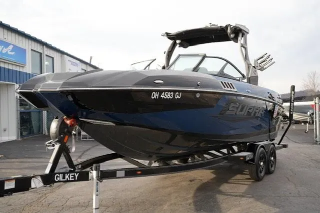 Slide: The Image of 2019 Supra SE 450 boat on trailer, parked outside dealership. - 2