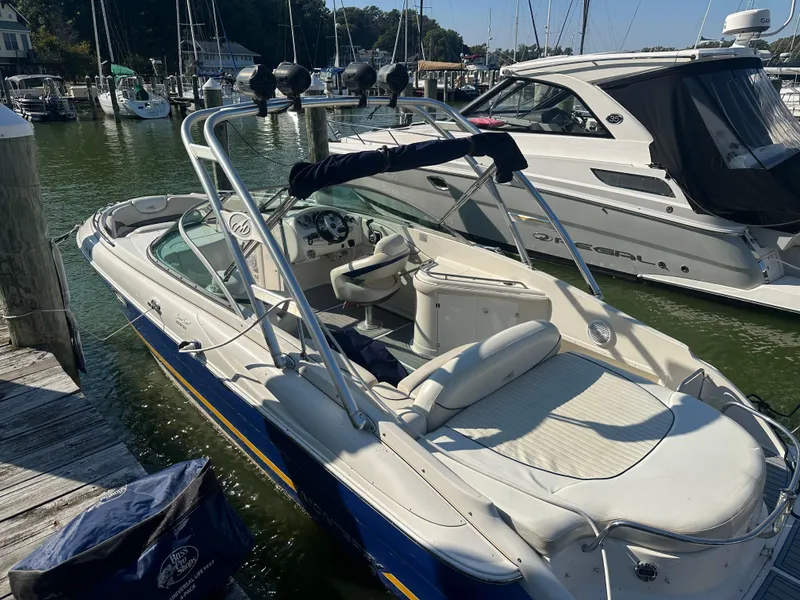 The Image of 2006 Monterey 268SS boat docked in marina, featuring sleek design and spacious seating. - 0