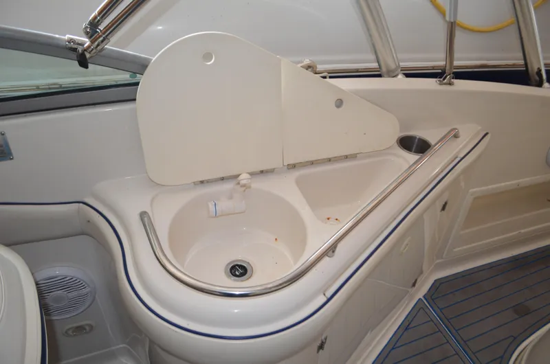 Slide: The Image of Interior view of a 2006 Monterey 268SS boat featuring a built-in sink and counter area. - 4
