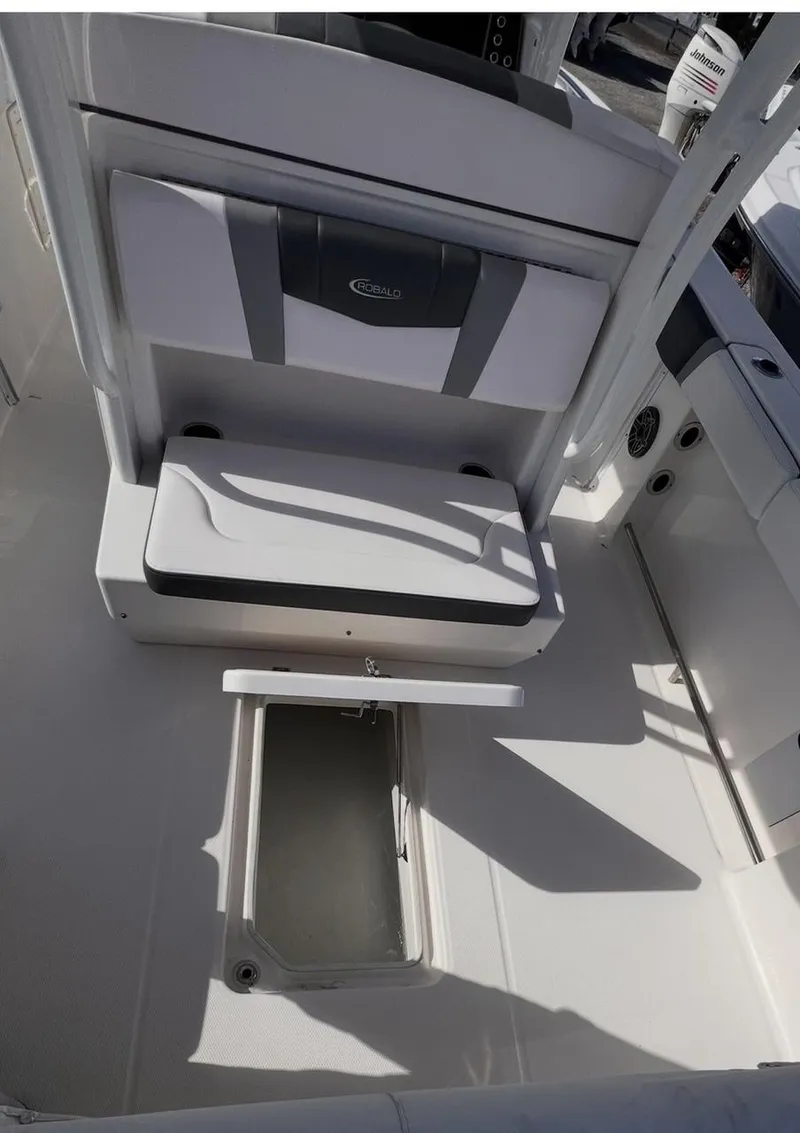 Slide: The Image of 2020 Robalo R272 Center Console boat interior with storage compartment open. - 10